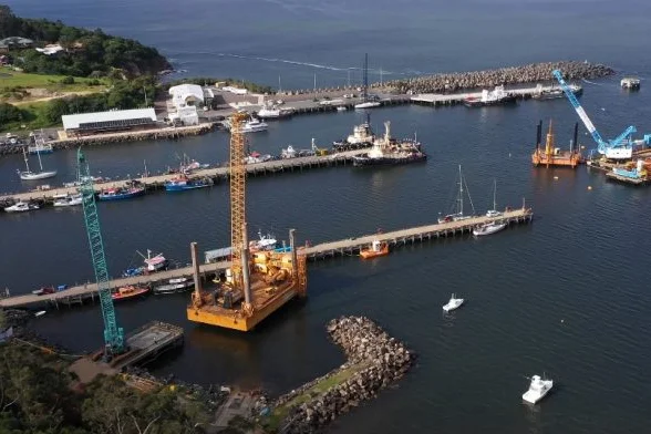 Jetty surrounded by cargo ship cranes